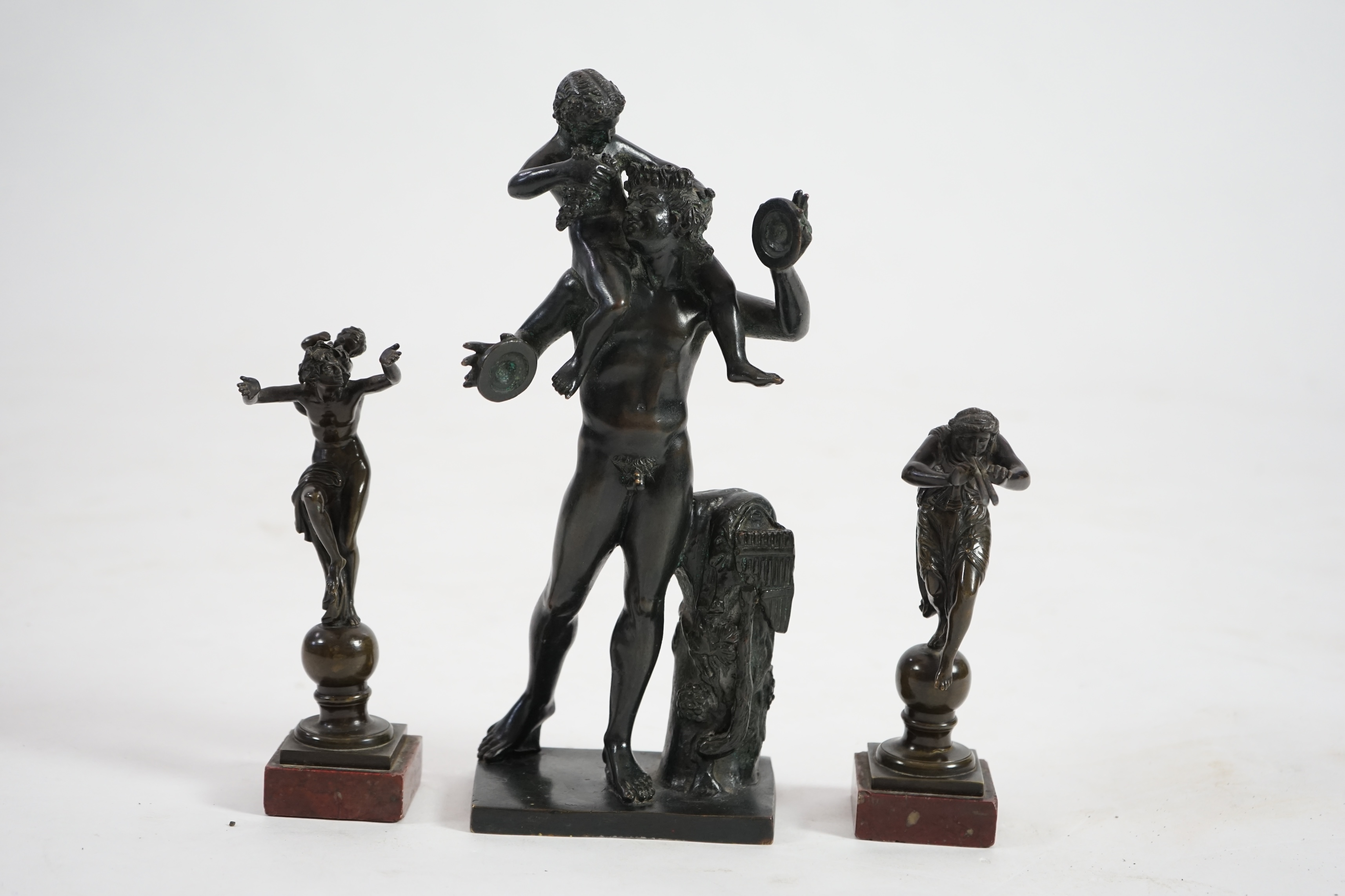 After the antique, three classical bronzes, faun with child Dionysius